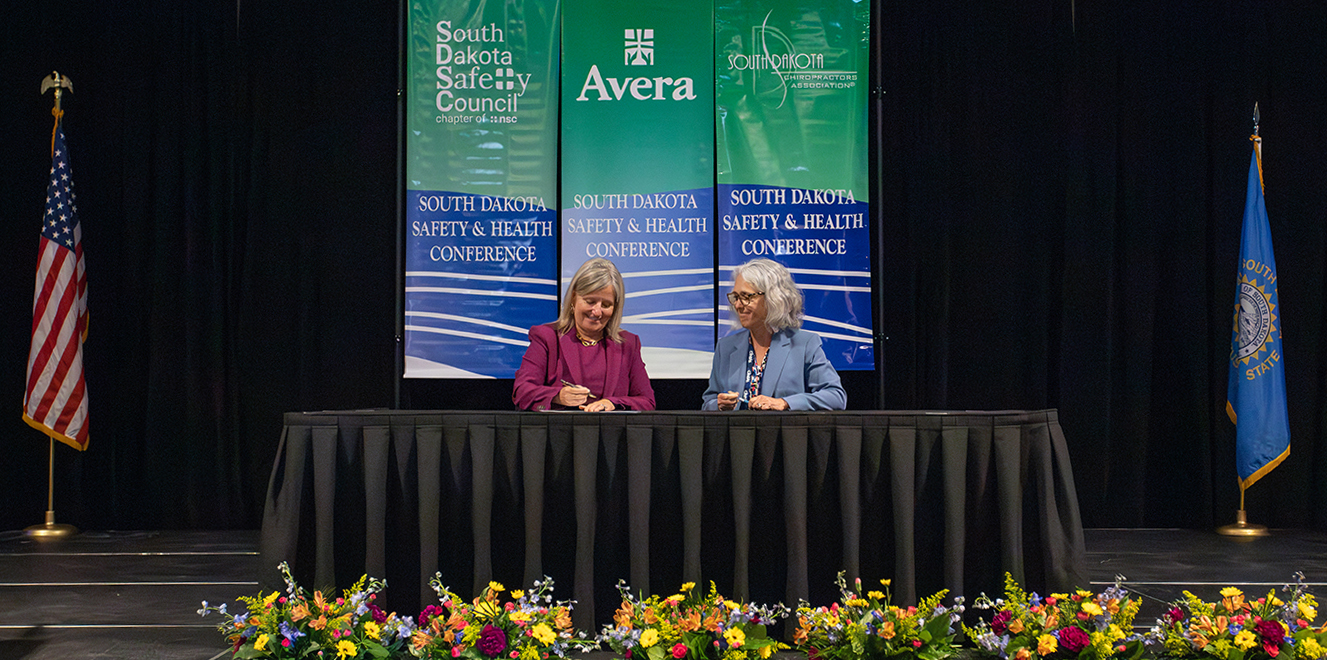 Janie and Sheila signing SDSC and OSHA Alliance